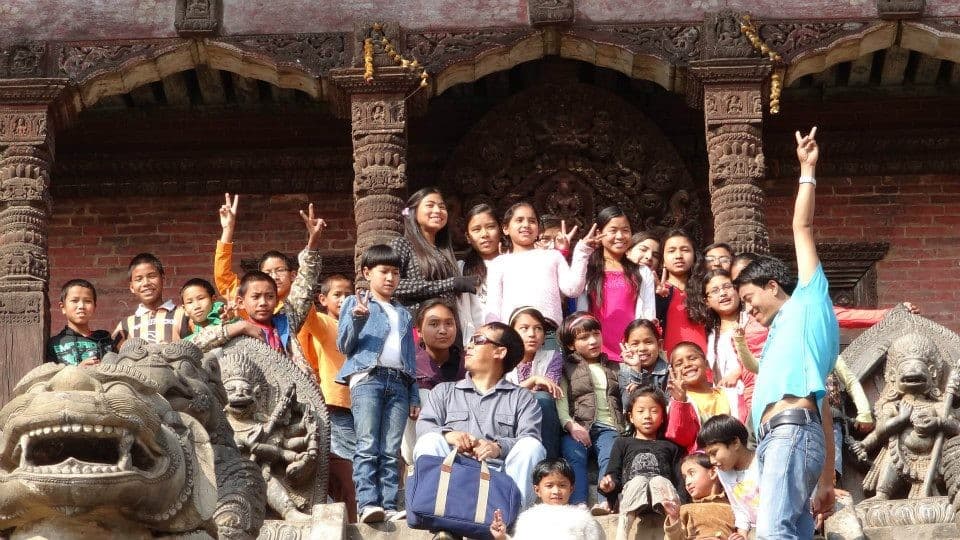 The Rainbow House kids on the temple lions, Bhaktapur, 2013.