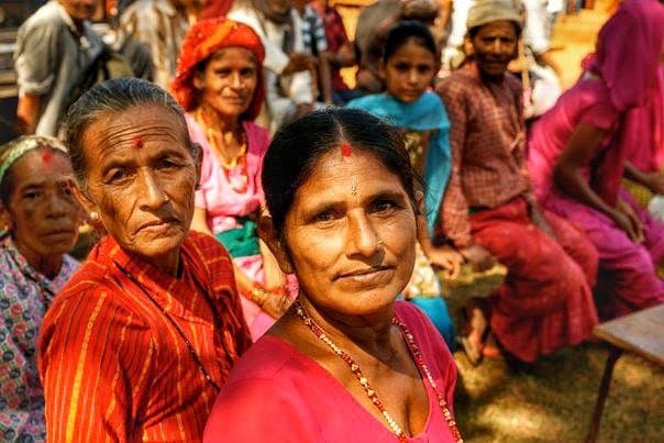 The women of the village, in the queue, dressed for the occasion.